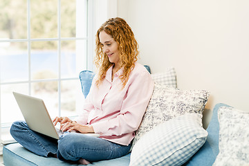 Image showing Woman using laptop computer at home