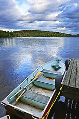 Image showing Rowboat docked on lake