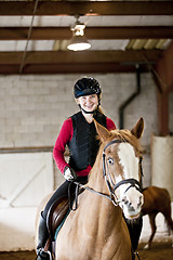 Image showing Teen girl riding horse