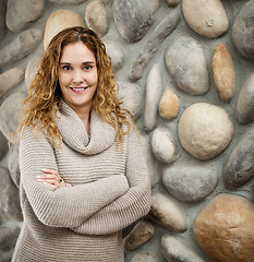 Image showing Woman in front of stone wall