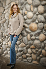 Image showing Woman in front of stone wall