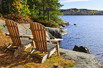 Image showing Adirondack chairs at lake shore