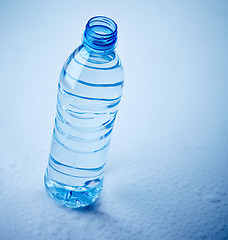 Image showing plastic water bottle on wet blue background