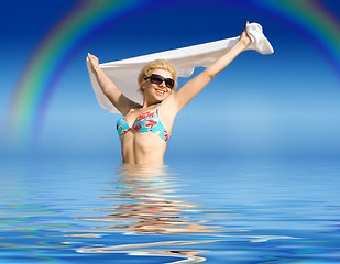 Image showing happy girl with towel standing in water