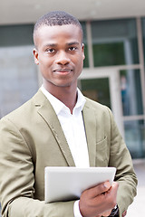 Image showing smiling successful businessman with tablet pc outdoor