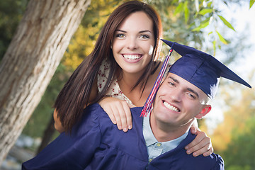 Image showing Male Graduate in Cap and Gown and Girl Celebrate