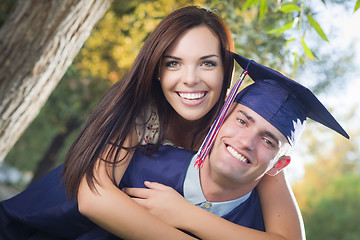 Image showing Male Graduate in Cap and Gown and Girl Celebrate