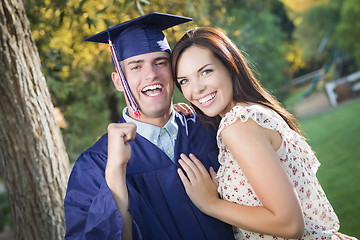 Image showing Male Graduate in Cap and Gown and Girl Celebrate