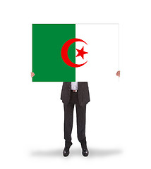 Image showing Businessman holding a big card, flag of Algeria