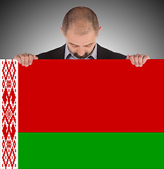 Image showing Businessman holding a big card, flag of Belarus