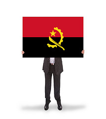 Image showing Businessman holding a big card, flag of Angola