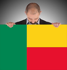 Image showing Businessman holding a big card, flag of Benin