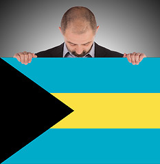 Image showing Businessman holding a big card, flag of the Bahamas