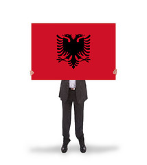 Image showing Businessman holding a big card, flag of Albania