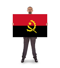 Image showing Businessman holding a big card, flag of Angola
