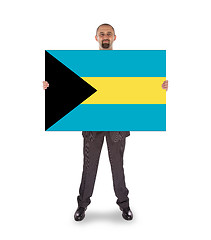 Image showing Businessman holding a big card, flag of the Bahamas