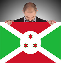 Image showing Businessman holding a big card, flag of Burundi