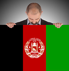 Image showing Businessman holding a big card, flag of Afghanistan