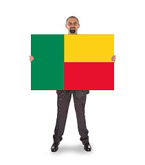 Image showing Businessman holding a big card, flag of Benin