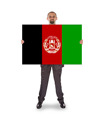 Image showing Businessman holding a big card, flag of Afghanistan