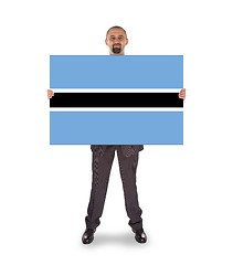 Image showing Businessman holding a big card, flag of Botswana