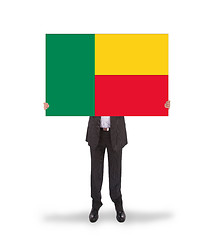 Image showing Businessman holding a big card, flag of Benin