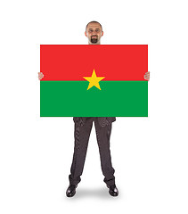 Image showing Businessman holding a big card, flag of Burkina Faso