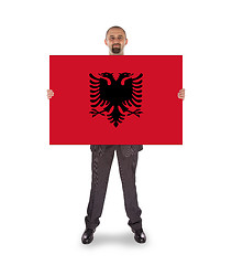 Image showing Businessman holding a big card, flag of Albania