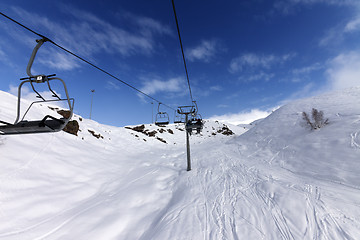 Image showing Chair-lift with skiers at winter mountains