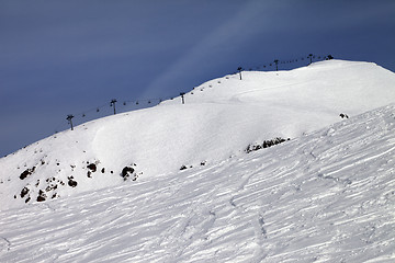 Image showing Off-piste slope and ropeway against blue sky