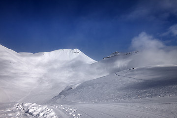 Image showing Ski slope with snowmobile trail in nice day