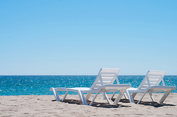 Image showing Two sunloungers