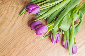 Image showing Violet tulips on the wood