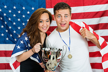 Image showing Athletes With Trophy And Medal Standing Against North American F