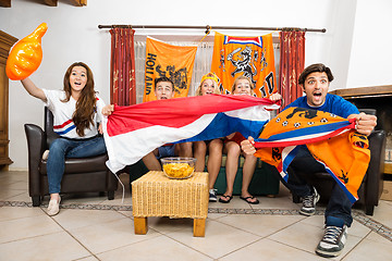 Image showing Soccer Fans Cheering While Watching Match At Home