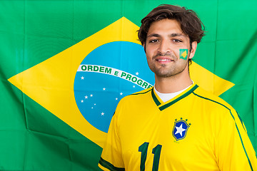 Image showing Confident Brazilian Supporter Standing in front of Brazilian Fla