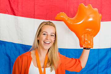 Image showing Sports fan Wearing an Inflatable orange Hand Cheering in front o