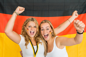 Image showing Successful Sportswomen Shouting Against German Flag