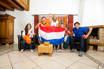 Image showing Soccer Fans Cheering While Watching Match At Home