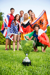 Image showing Championship Trophy With Athletes Of Various Nations