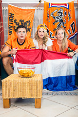 Image showing Curious Soccer Fans Watching Match At Home