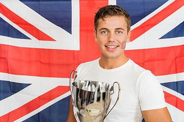 Image showing Sportswoman With Trophy Standing Against British Flag