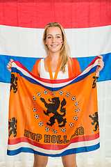 Image showing Dutch Sports fan Holding Cheering Flag in Front of Holland Flag