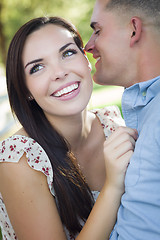 Image showing Mixed Race Romantic Couple Whispering in the Park