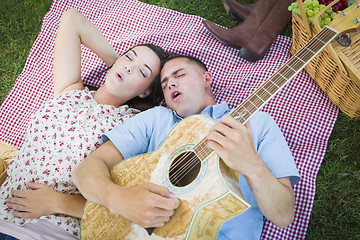 Image showing Mixed Race Couple at the Park Playing Guitar and Singing