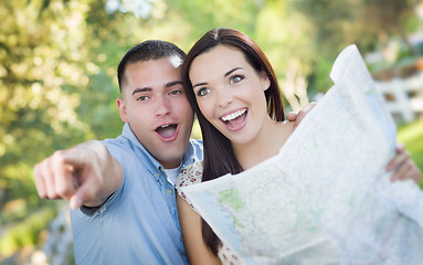 Image showing Mixed Race Couple Looking Over Map Outside Together