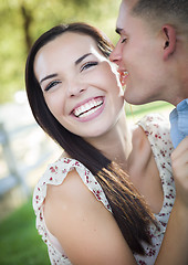 Image showing Mixed Race Romantic Couple Whispering in the Park