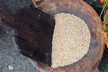 Image showing Wooden spoon and wheat