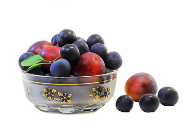 Image showing Plums and prunes in a vase for fruit on a white background.