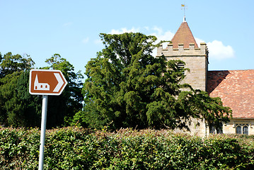 Image showing Tourist sign points towards historic church